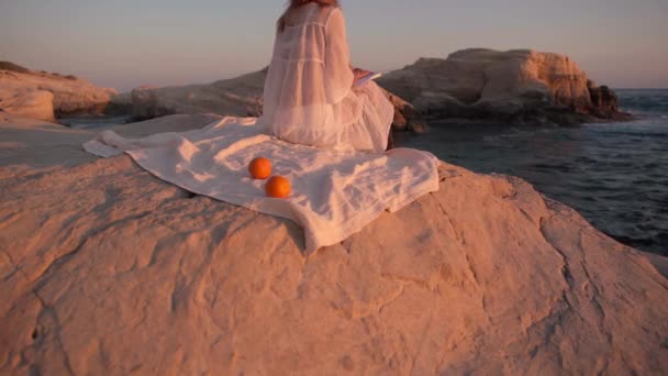 Λευκός Βράχος Στο Χρυσό Ηλιοβασίλεμα Αγνώριστη Γυναίκα Κάθεται Θαυμάζοντας Δύση — Αρχείο Βίντεο