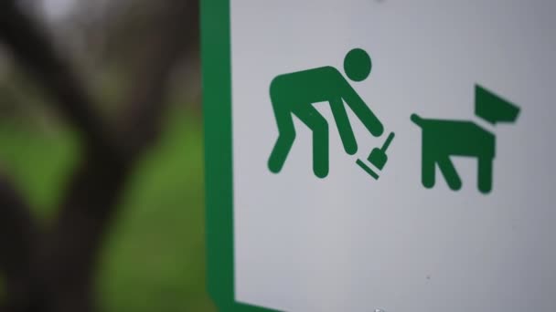 あなたの犬の後できれいな公園の閉鎖サイン 屋外のプレートにペットを塗った緑の男 — ストック動画