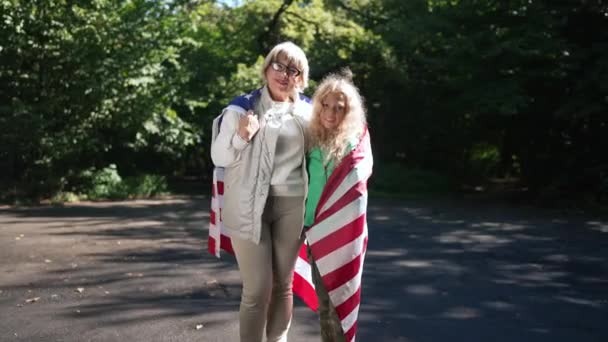 Confident Smiling Grandmother Granddaughter American Flag Looking Camera Standing Sunshine — Stock Video