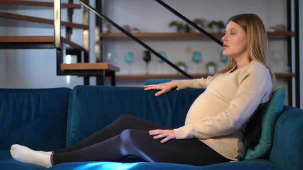 Sad Pregnant Woman Hugging Belly Thinking Lying Sofa Living Room — Stock Video