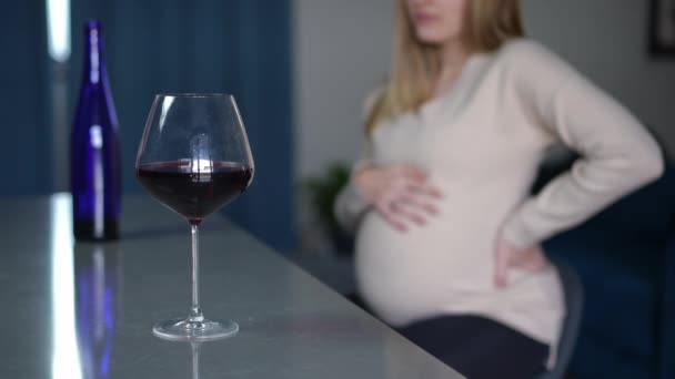 Rack Focus Van Rode Wijn Glas Aan Bedachtzame Zwangere Jonge — Stockvideo