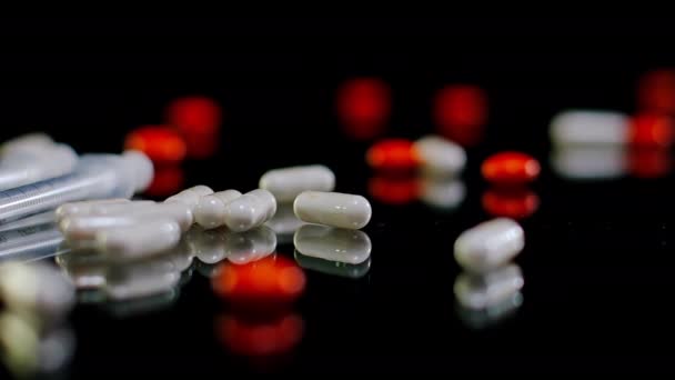 Großaufnahme Weißer Und Roter Pillen Auf Dem Tisch Mit Spritzen — Stockvideo