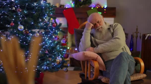 Starszy Mężczyzna Zasnął Pobliżu Choinki Bujanym Krześle Poduszką — Wideo stockowe