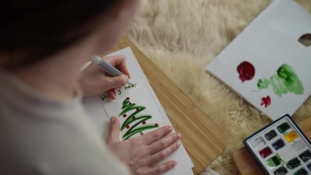 Μια Αριστερόχειρας Γυναίκα Υπογράφει Μια Σπιτική Κάρτα Πρωτοχρονιάς Ένα Πράσινο — Αρχείο Βίντεο