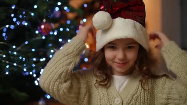 Close Girl Wearing Christmas Hat Looking Cheerfully Camera — Stock Video
