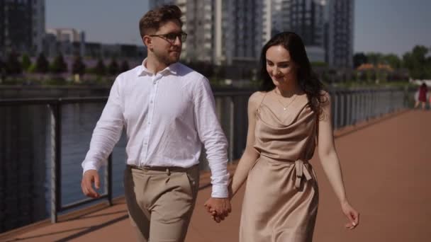 Slow Motion Happy Young Couple Holding Hands Walks Pier Talking — Stock Video