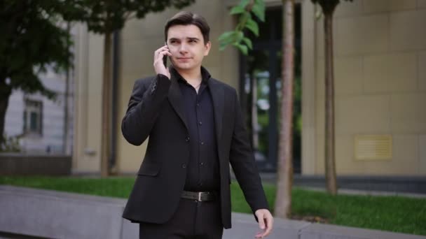 Homem Negócios Responde Telefonema Móvel Enquanto Está Livre Contra Pano — Vídeo de Stock