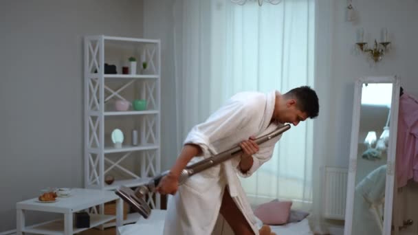 Cheerful Guy White Bathrobe Dances Sings While Cleaning Bedroom House — Stock Video