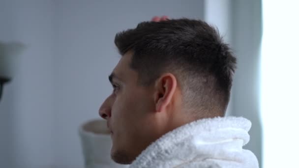 Close Man White Bathrobe Standing Front Bathroom Mirror Straightens His — Stock Video
