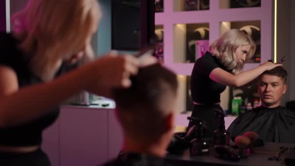 Young Female Hairdresser Concentrates Doing Mans Haircut While Standing Modern — Stock Video