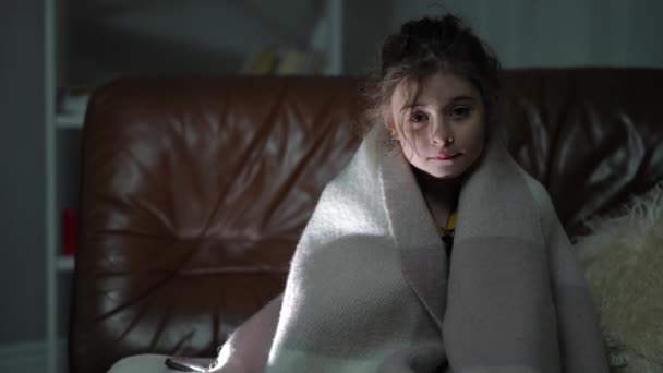 Cute Girl Wrapped Plaid Looking Camera Sitting Dark Sofa Living — Stock Video