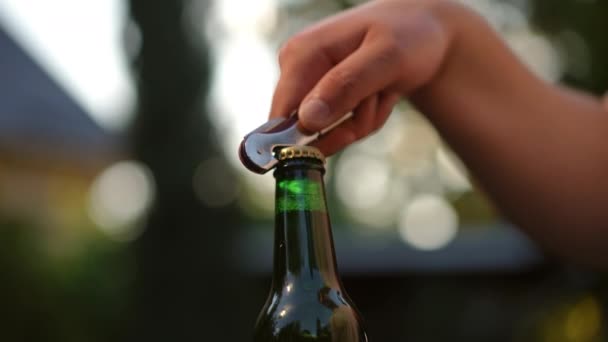Zbliżenie Męska Ręka Otwiera Zieloną Szklaną Butelkę Pomocą Otwieracza Piwa — Wideo stockowe