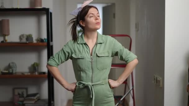 Pretty Woman Overalls Has Finished Painting Walls Standing Her Hands — Stock Video