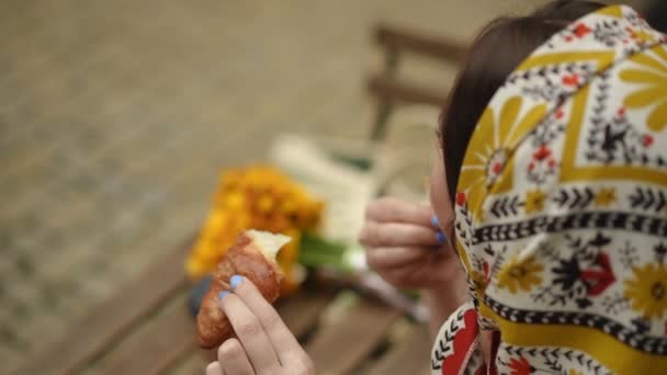 Gerakan Lambat Bahu Ditembak Seorang Wanita Dengan Kerudung Makan Croissant — Stok Video