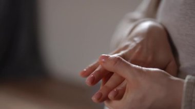 Güzel gümüş bir yüzüğü nazikçe tutan, sevgi ve bağlılığın güçlü hislerini uyandıran ellerin yakın çekimi.