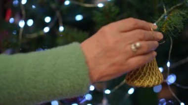 A beautifully lit Christmas tree that is adorned with colorful ornaments and shimmering, twinkling lights all around