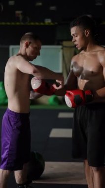 İki sporcu yoğun bir şekilde boks eğitimi alıyor, etkileyici bir teknik, odaklanma ve güçlü bir takım çalışması sergiliyorlar.