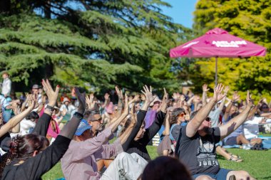 South Australia, Australia  12-02-2023: Kumangka Palti Yarta - Indigenous Welcome Ceremony, Kaurna leaders provide the Aboriginal ritual rite at a community event in Adelaide, people hold hands up