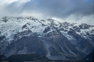 Dağ manzarası, kazmalarda kar, bulutlu gökyüzü. Cook Dağı, Yeni Zelanda, Güney Adası. Güzel manzara. 