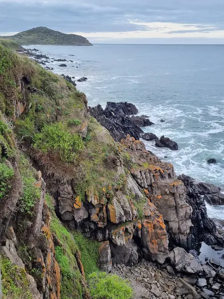 stock image Ocean coast in South Australia, rocks, unusual black stones. Clouds and lines. Seascape. 