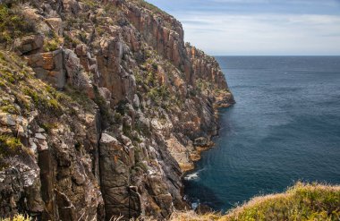 Breathtaking view of Cape Hauy Tasmania featuring rugged cliffs lush greenery and the vast ocean, Australia. High quality photo clipart