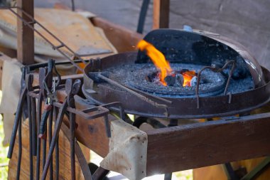 Geleneksel kalpazanlık gösterisi sırasında demir çubuğu çekiçle örse tutan demircilerin yakın çekimi. Yüksek kalite fotoğraf