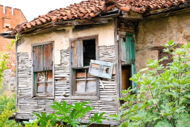 Facade of an old abandoned village house destroyed by time