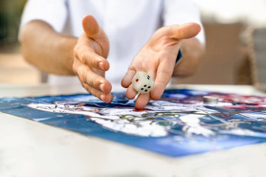 Mans Hands Close-Up Attrowing Die on Play of Leelas Game for Self-Discovery, Türkiye, Alanya - 14 Nisan 2024