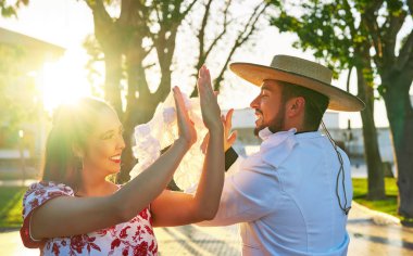portrait young adult latin american couple dancing cueca national dance in huaso dress in the city square clipart