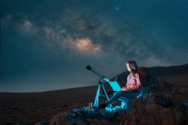 digital nomad woman sitting in the desert with a laptop next to a telescope at night under the stars and milky way, astronomy and stargazing concept	 clipart