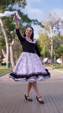 Şilili Huaso kostümlü genç bir kadının portresi meydanda poz veriyor, Şili Patrias kutlamaları.