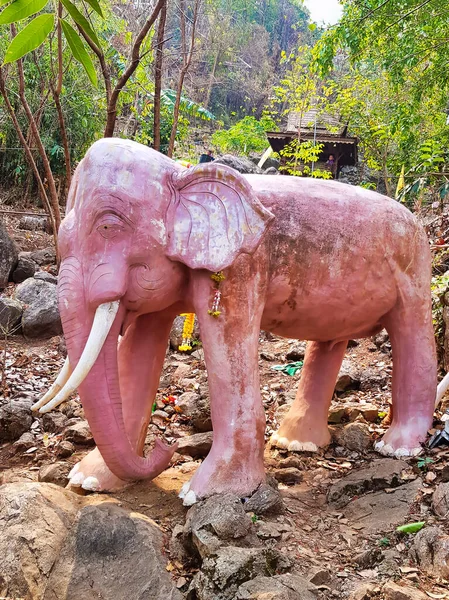 Statue of a pink elephant on the grounds of the buddhist rock temple Wat Phra That In Kwaen, Phrae province, Thailand