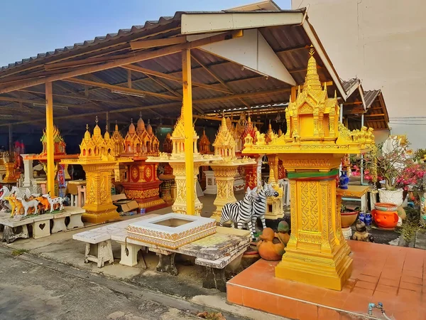 Open air shop with spirit houses and the religious paraphernalia in Bangkok, Thailand
