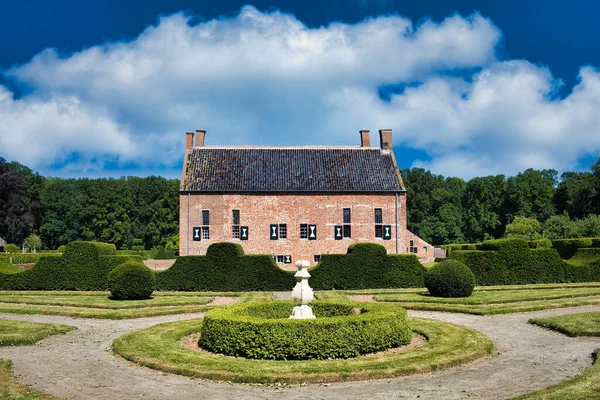 stock image The 16th-century castle Menkemaborg (now an museum) in Uithuizen, Groningen, the Netherlands, with topiary and formal French garden