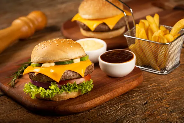 Burger, cheese burger with sauces and fries.