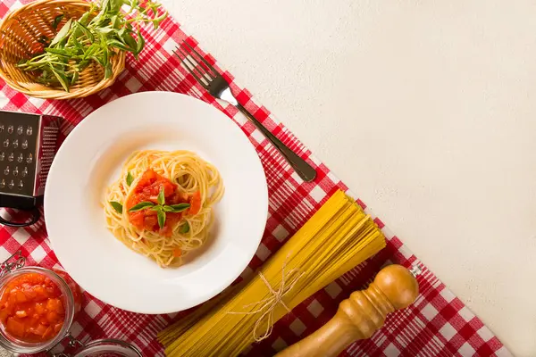在番茄酱和罗勒中加入意大利面 — 图库照片