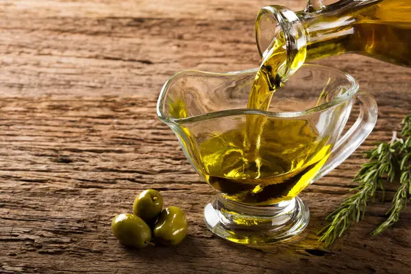 Bottle Pouring Virgin Olive Oil Bowl — Stock Photo, Image