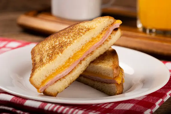 Grilled ham and cheese. Sandwich with cheese and ham on grill.