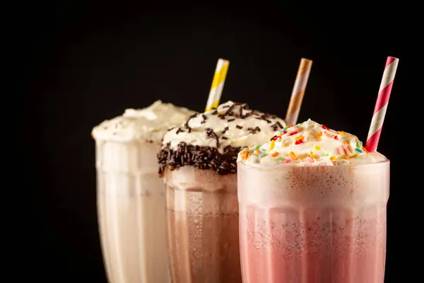 Three Glasses Milkshake Assorted Flavors Chocolate Vanilla Strawberry Milkshake — Stock Photo, Image