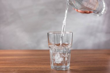 Glass of fresh water on the table. clipart