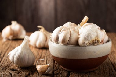 Sarımsak ampul ve ahşap masa üzerinde diş sarımsak.