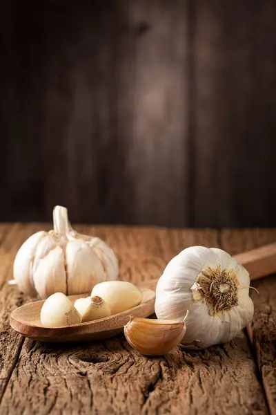 Garlic bulb and garlic cloves on the wooden table.