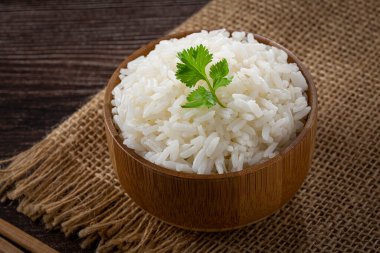 Bowl with cooked rice on the table. clipart