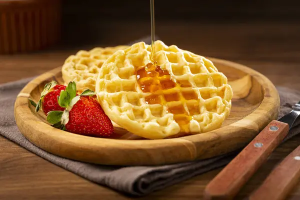 Delicious waffles. Plate with baked waffles on the table.