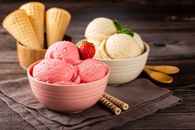 Bowls with strawberry and vanilla ice cream. clipart