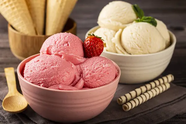 Bowls with strawberry and vanilla ice cream.