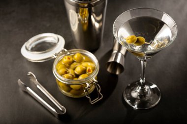 Dry martini drink with green olives. clipart