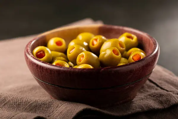 Stuffed green olives in a bowl.