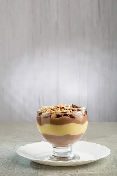 Dessert in the glass. Pastry cream dessert with chocolate ganache.