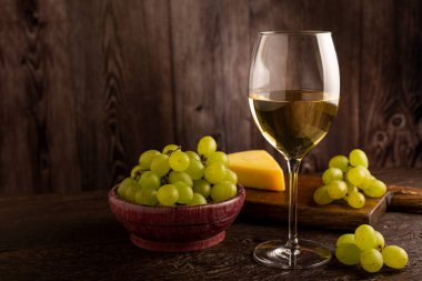 Masanın üzerinde bir bardak beyaz şarap..